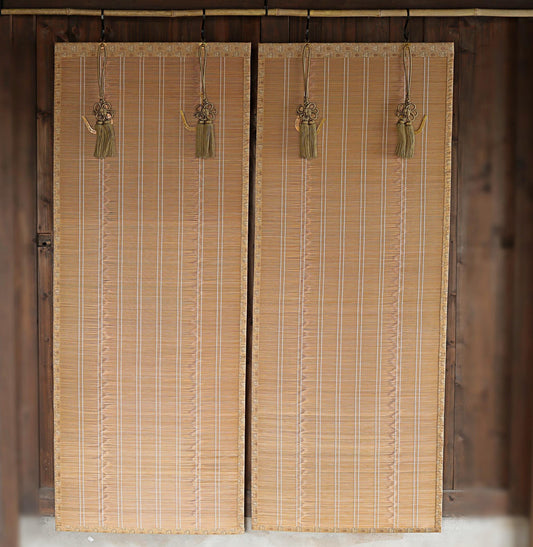 a pair of wooden blinds hanging on a wall, with tassels hanging from them.