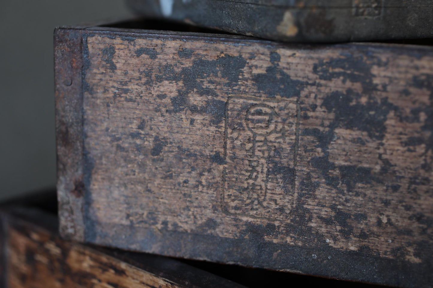 a close-up view of a weathered, wooden surface with a faded, distressed appearance.