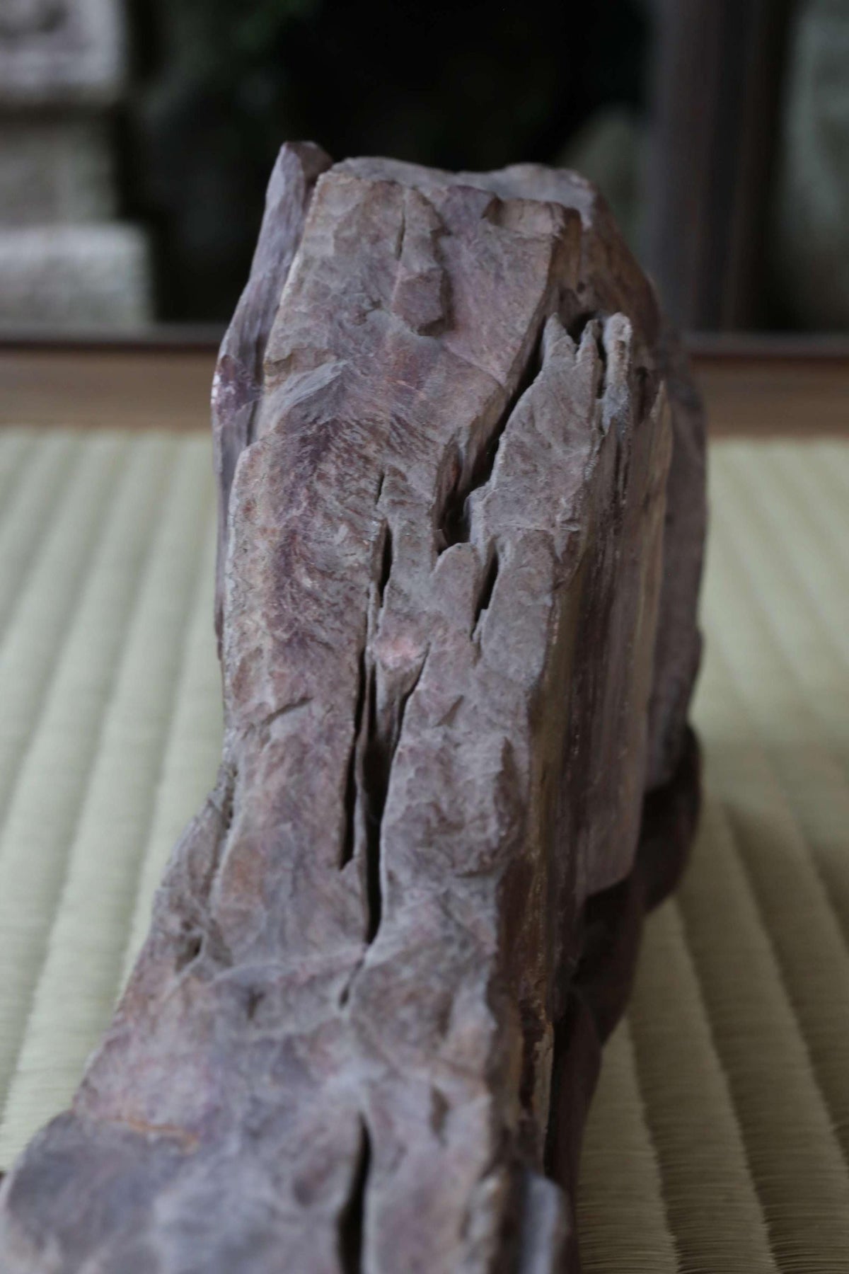 a close-up view of a large, jagged rock with a rough, uneven surface.