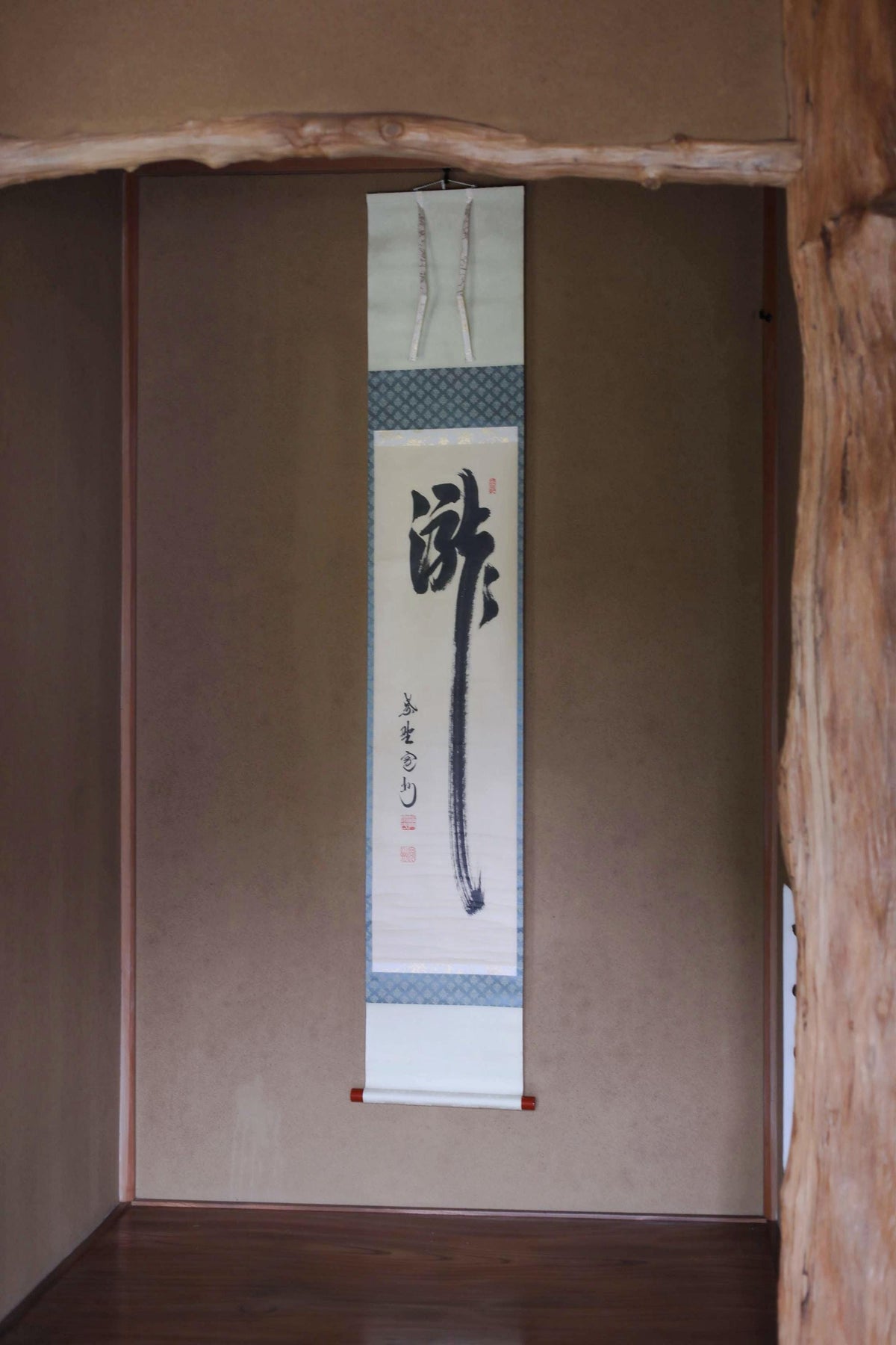 a traditional Japanese scroll hanging on a wall.