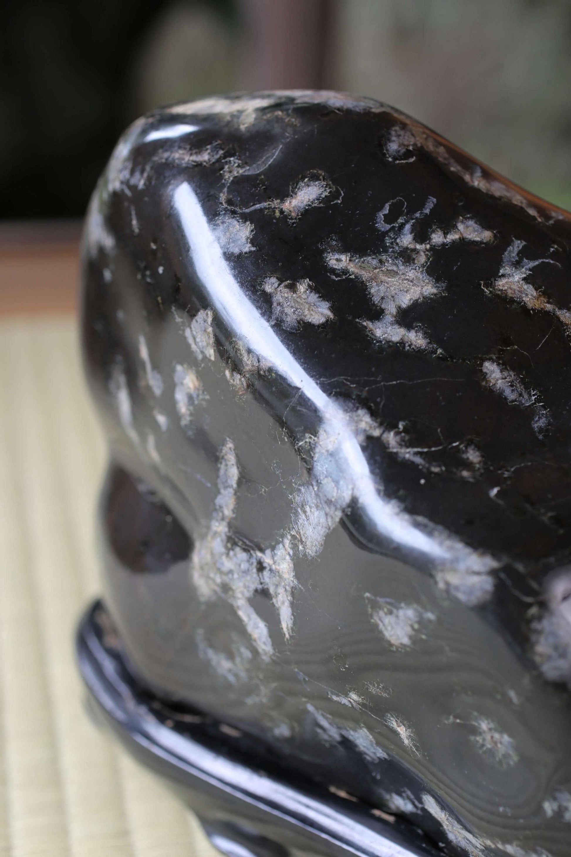 a close-up view of a black, textured surface with a speckled pattern.