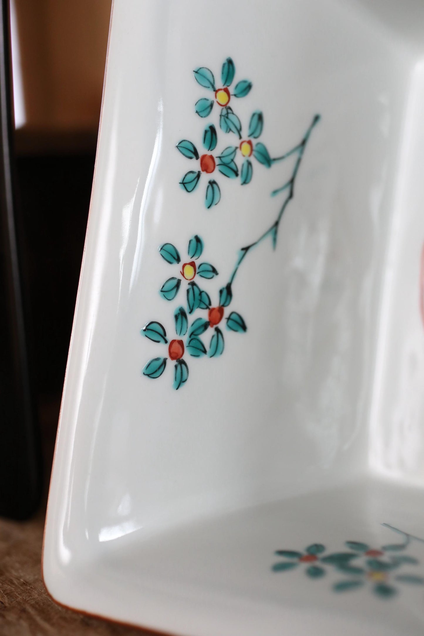 a close-up view of a white ceramic dish with a floral design on it.