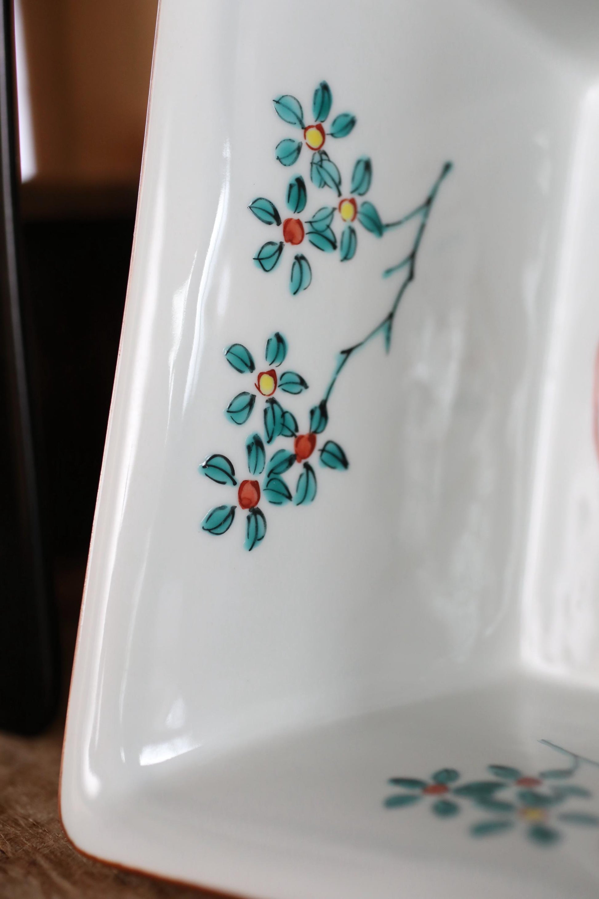 a close-up view of a white ceramic dish with a floral design on it.