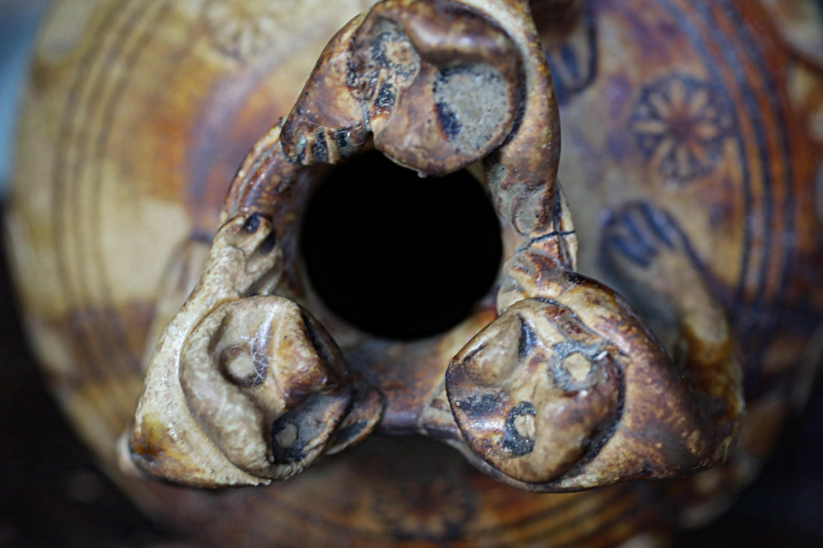 a close-up view of a ceramic vase with a hole in the center, revealing the intricate details of the vase's design.