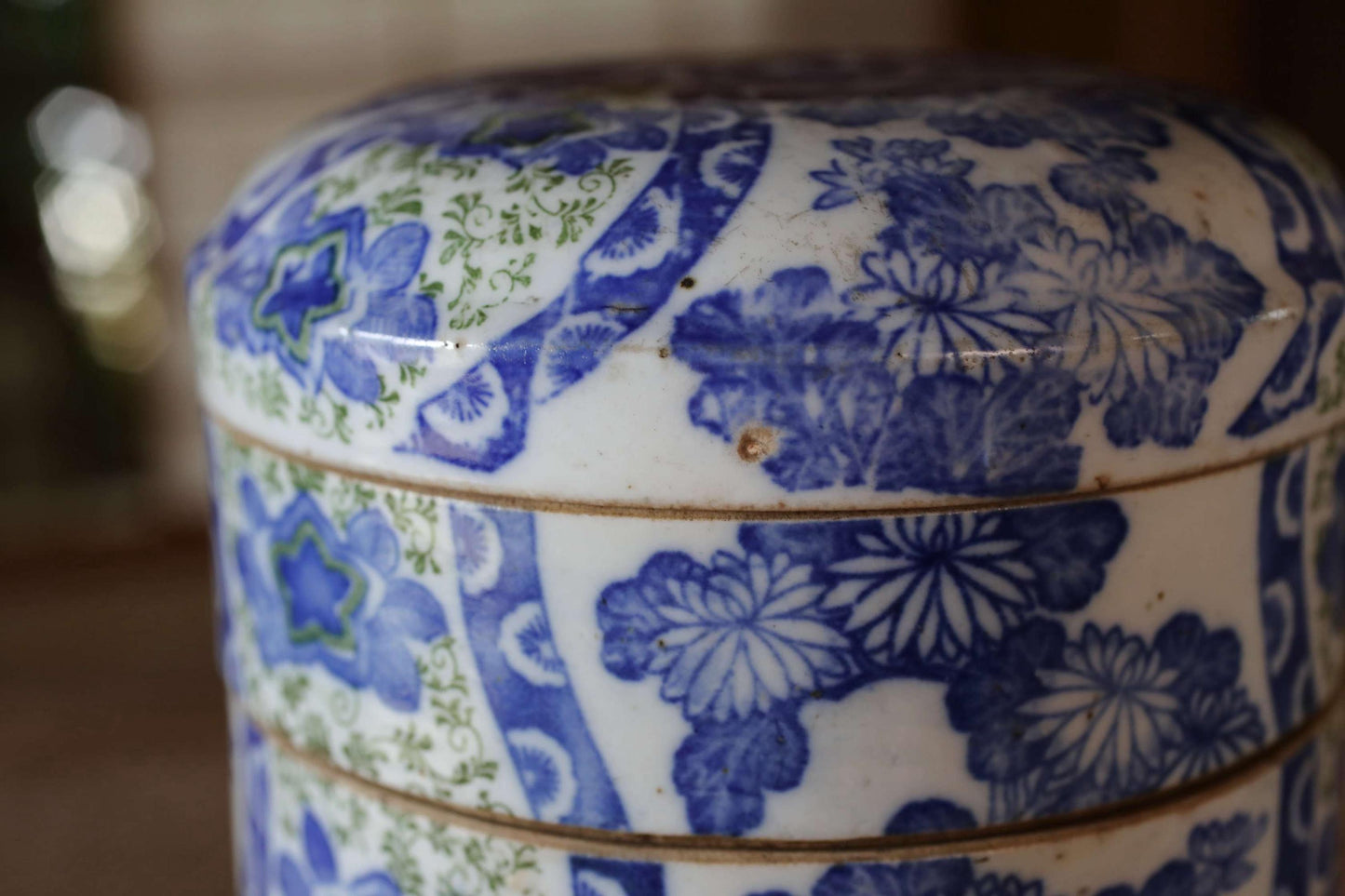A close-up view of a decorative ceramic container with a blue and white floral pattern.