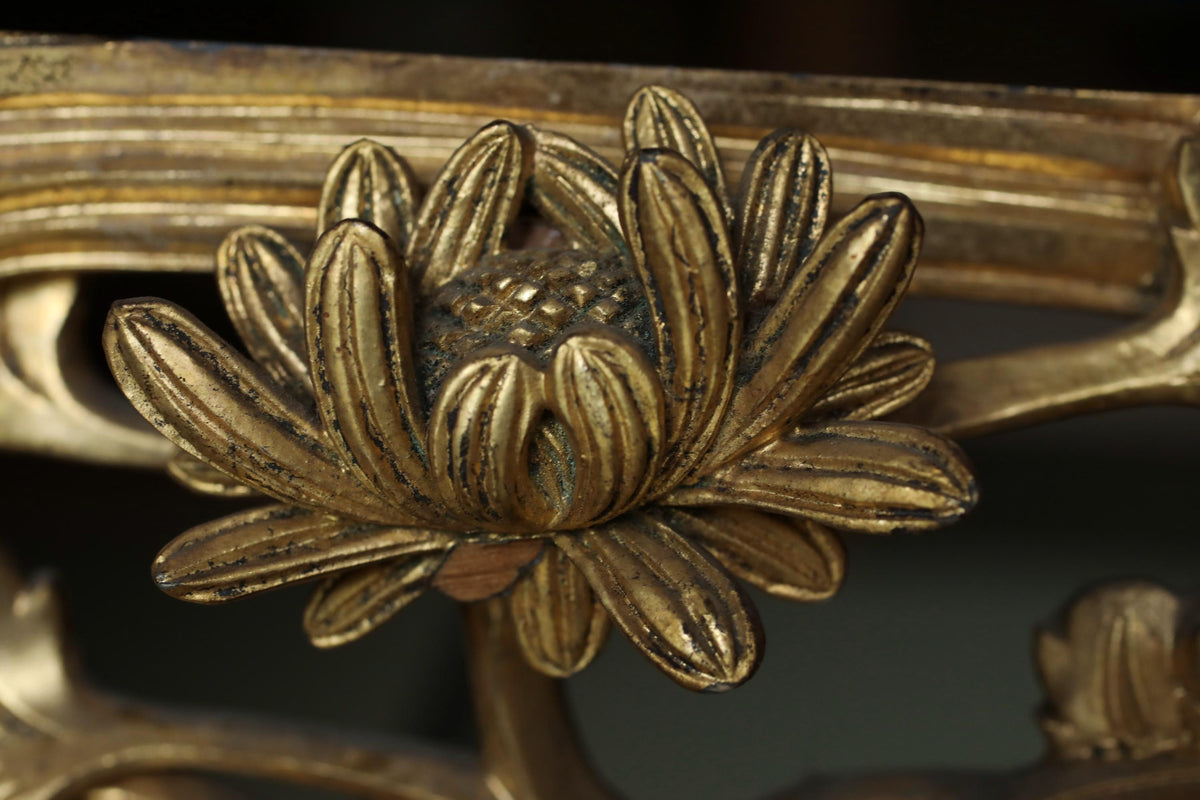 A close-up view of a decorative golden flower-like object, possibly a piece of furniture or an ornamental piece.