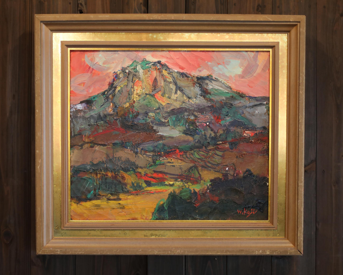 The image is a framed painting depicting a mountainous landscape with a vibrant, colorful sky.