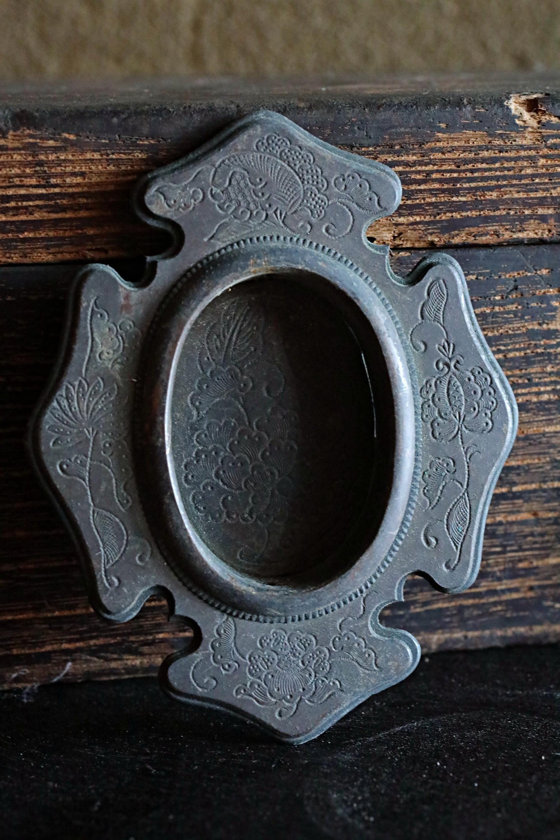 a close-up view of an ornate, antique-looking metal piece with intricate floral designs.
