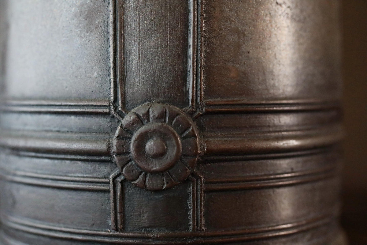 a close-up view of a metal object with a decorative design on its surface.