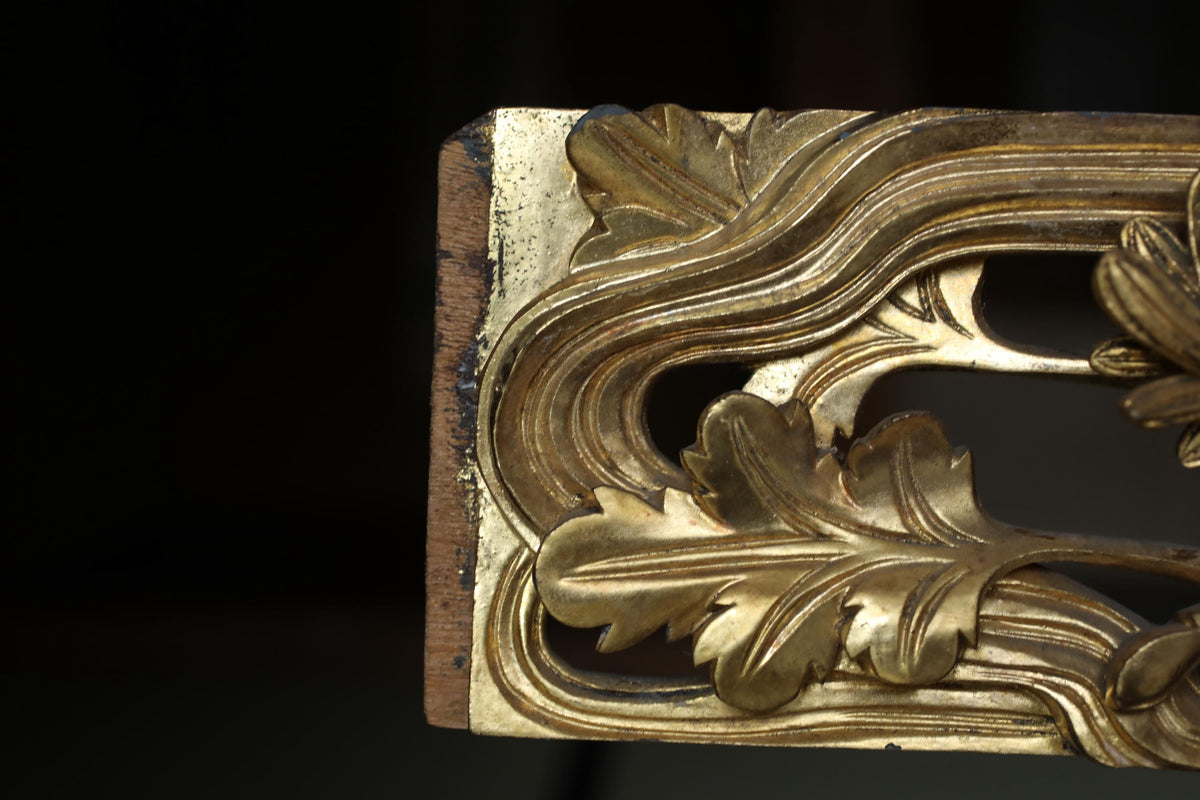 a close-up view of a decorative metal piece with intricate leaf-like designs.