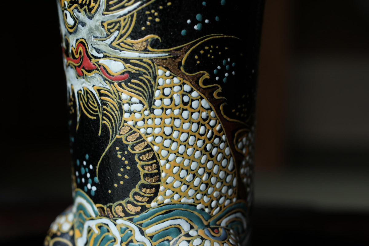 a close-up view of a decorative vase with intricate patterns and designs, including a dragon motif.