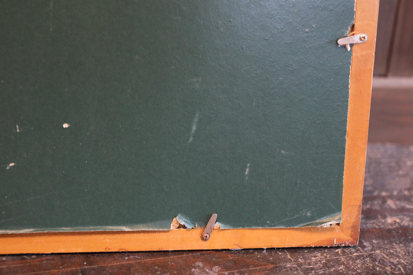 a close-up view of a green, textured surface with a wooden frame.