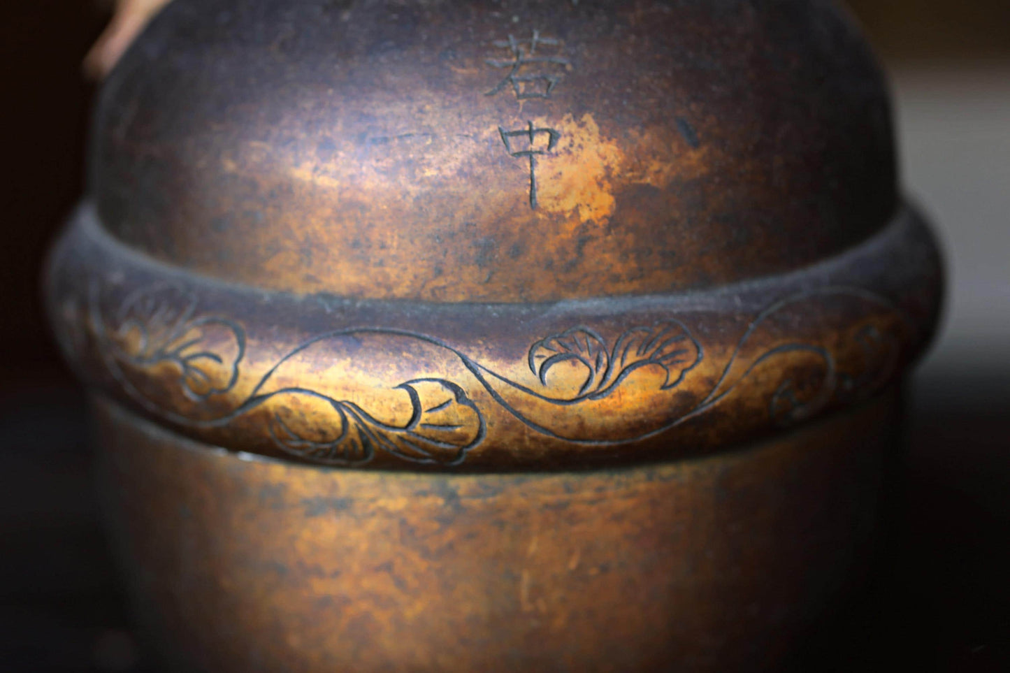 a close-up view of a metal object with a decorative design on its surface.