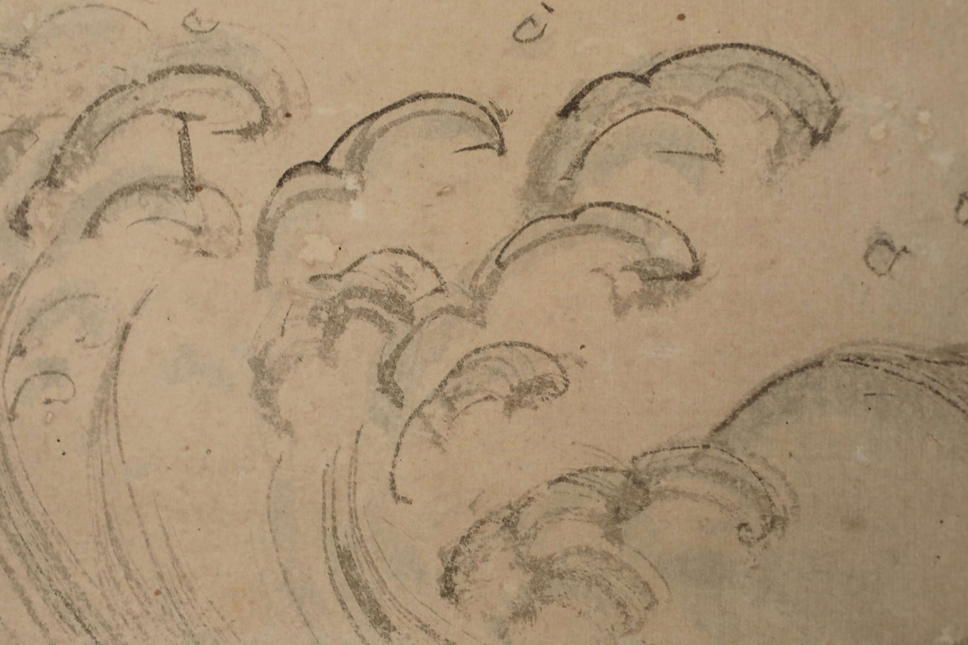 a close-up view of a sketch or drawing of a wave, with various lines and shapes used to create the wave-like pattern.