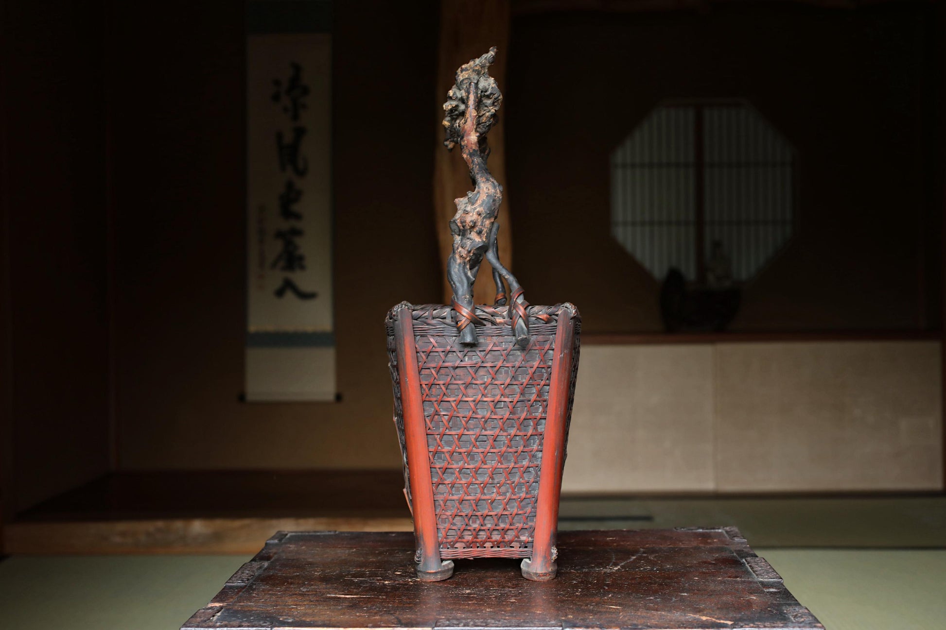 a wooden box with a decorative metal lid, placed on a wooden surface.