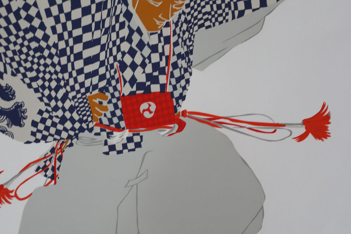 a person wearing a checkered shirt and holding a red object with a white symbol on it.