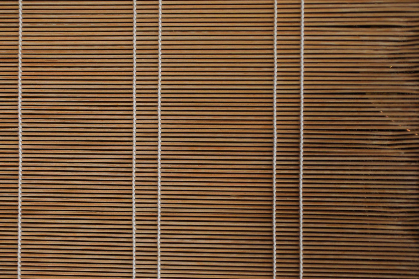 a close-up view of a wooden blind with vertical slats, creating a textured and patterned appearance.