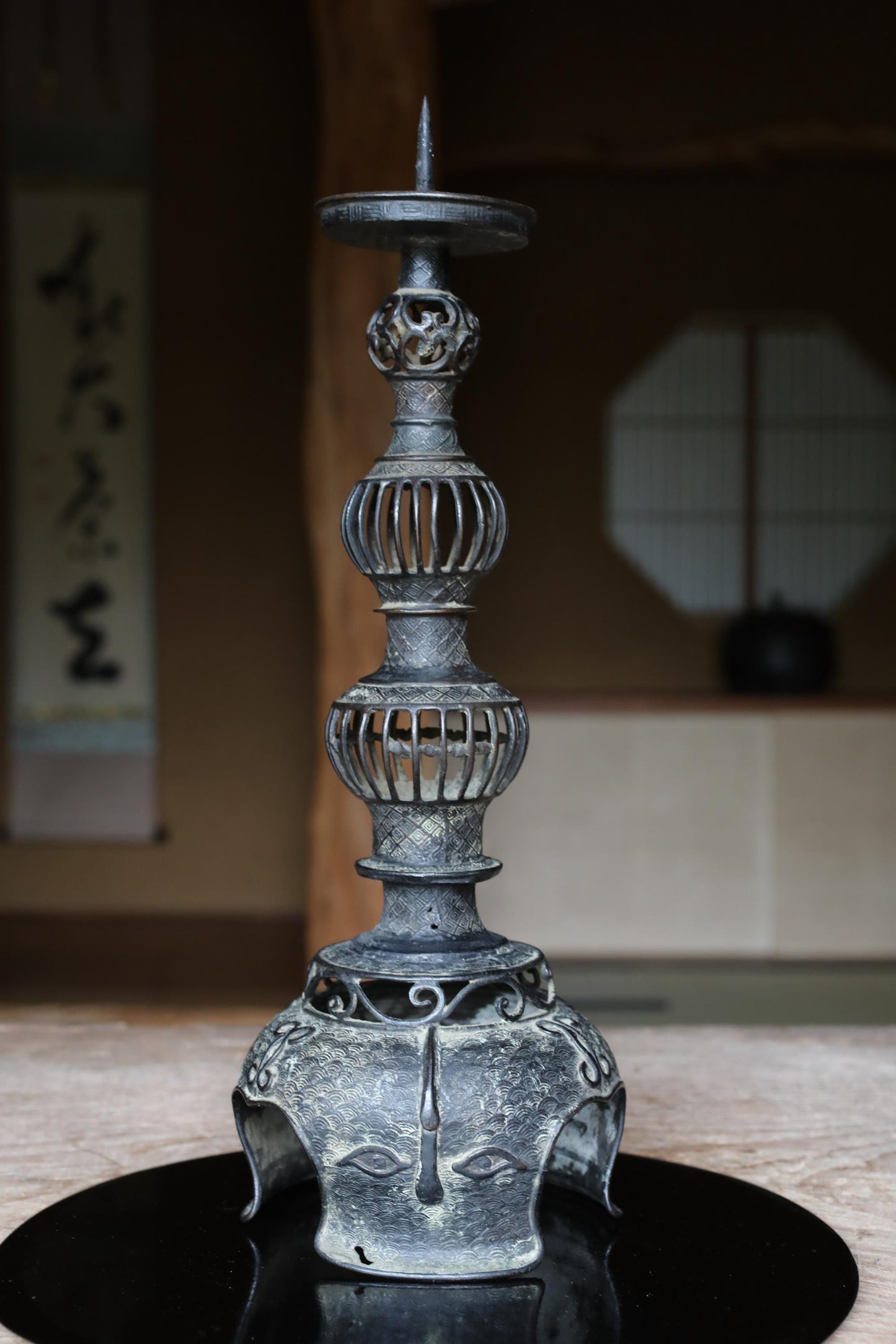 a decorative metal candlestick with an ornate, multi-tiered design.