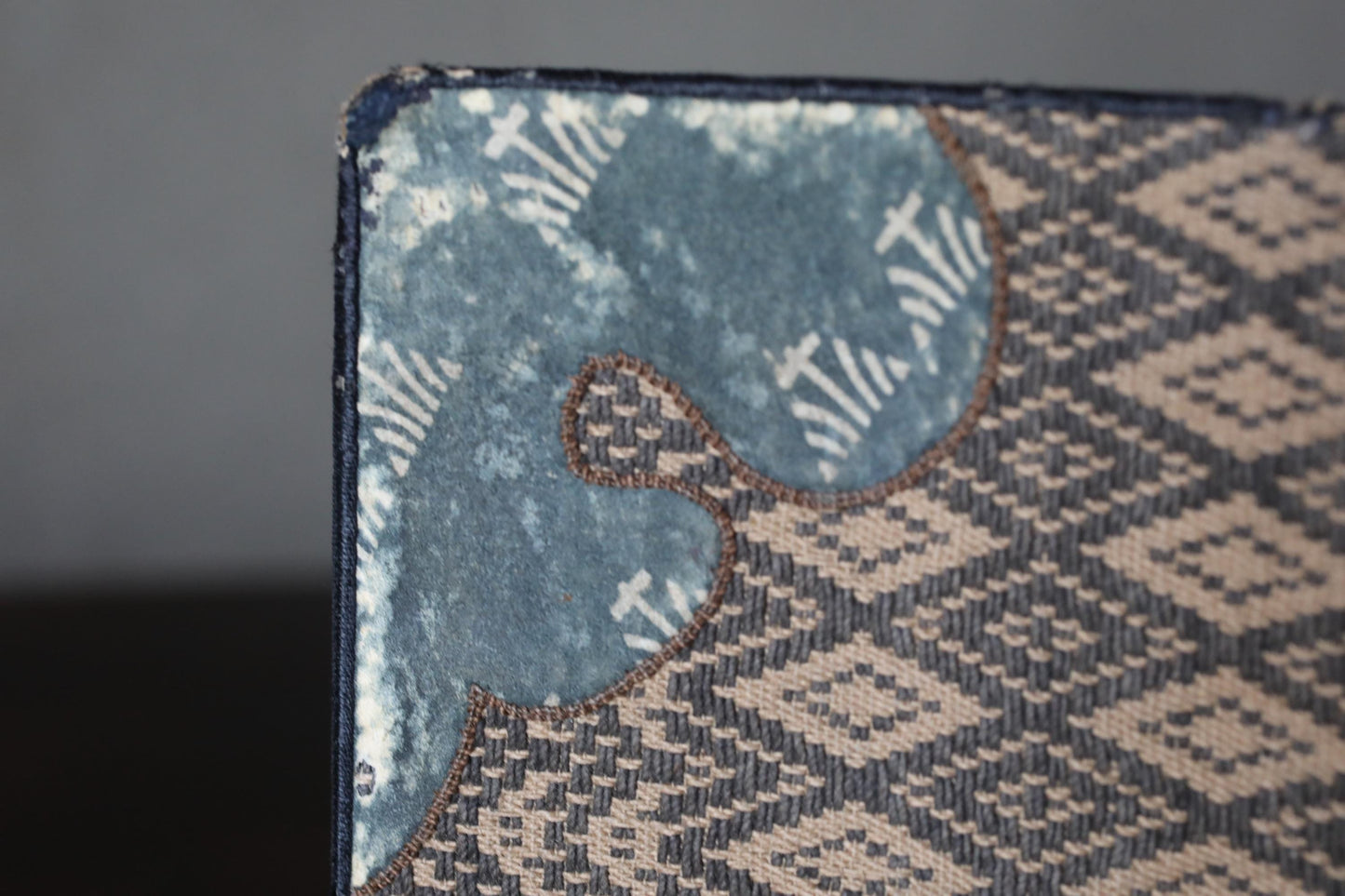a close-up view of a textured fabric with a patterned design, featuring a blue and white color scheme.