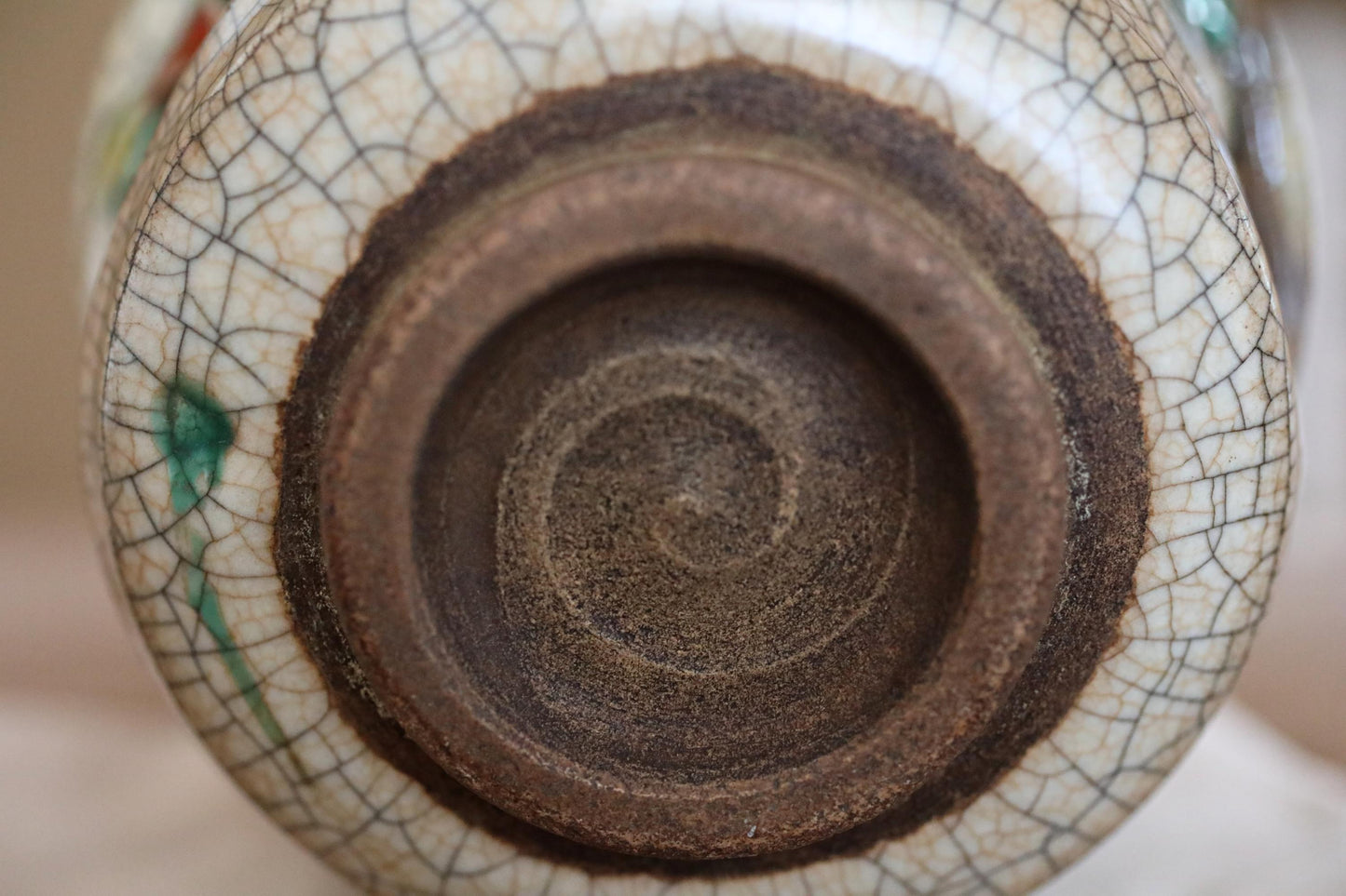 A close-up view of a ceramic vase with a spiral pattern on its surface.