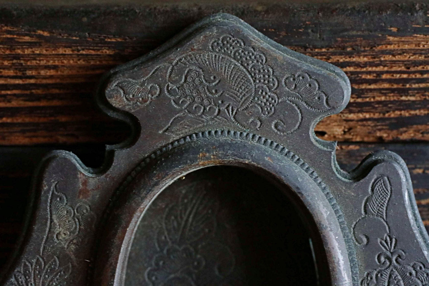 a close-up view of an ornate, antique-looking metal object with intricate, decorative patterns.