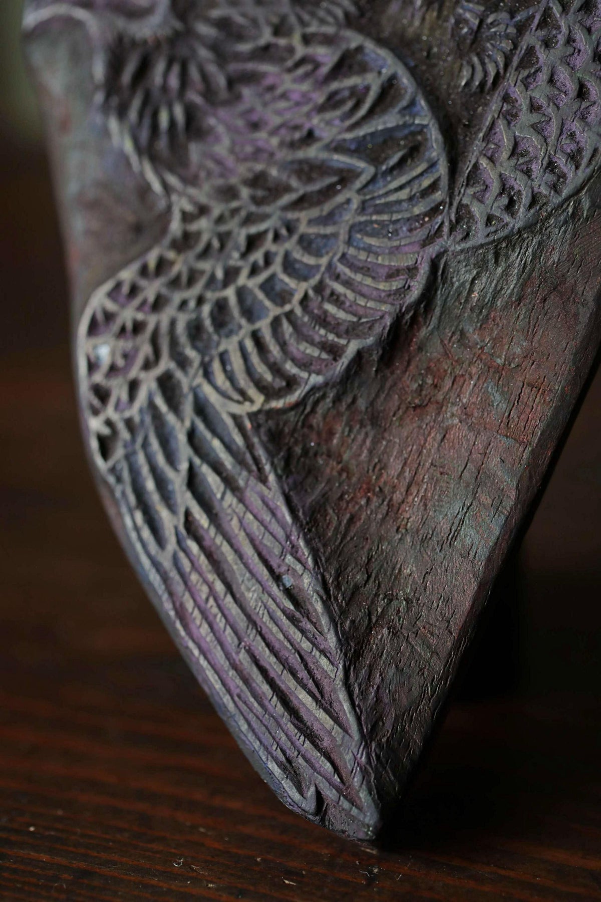 a close-up view of a wooden sculpture with intricate, detailed patterns carved into its surface.