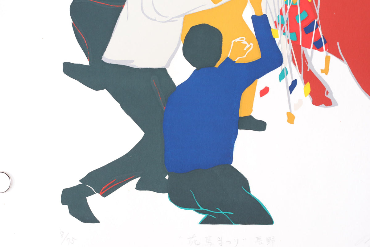 a person in a blue shirt and black pants, holding a string of colorful objects, possibly balloons or streamers, and appears to be reaching up to them.