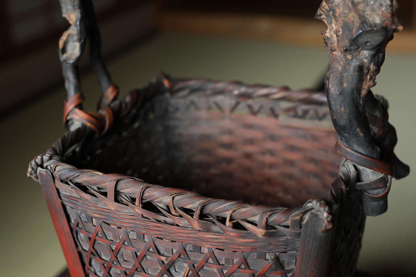 a close-up view of a woven basket with a dark brown color and intricate patterns.