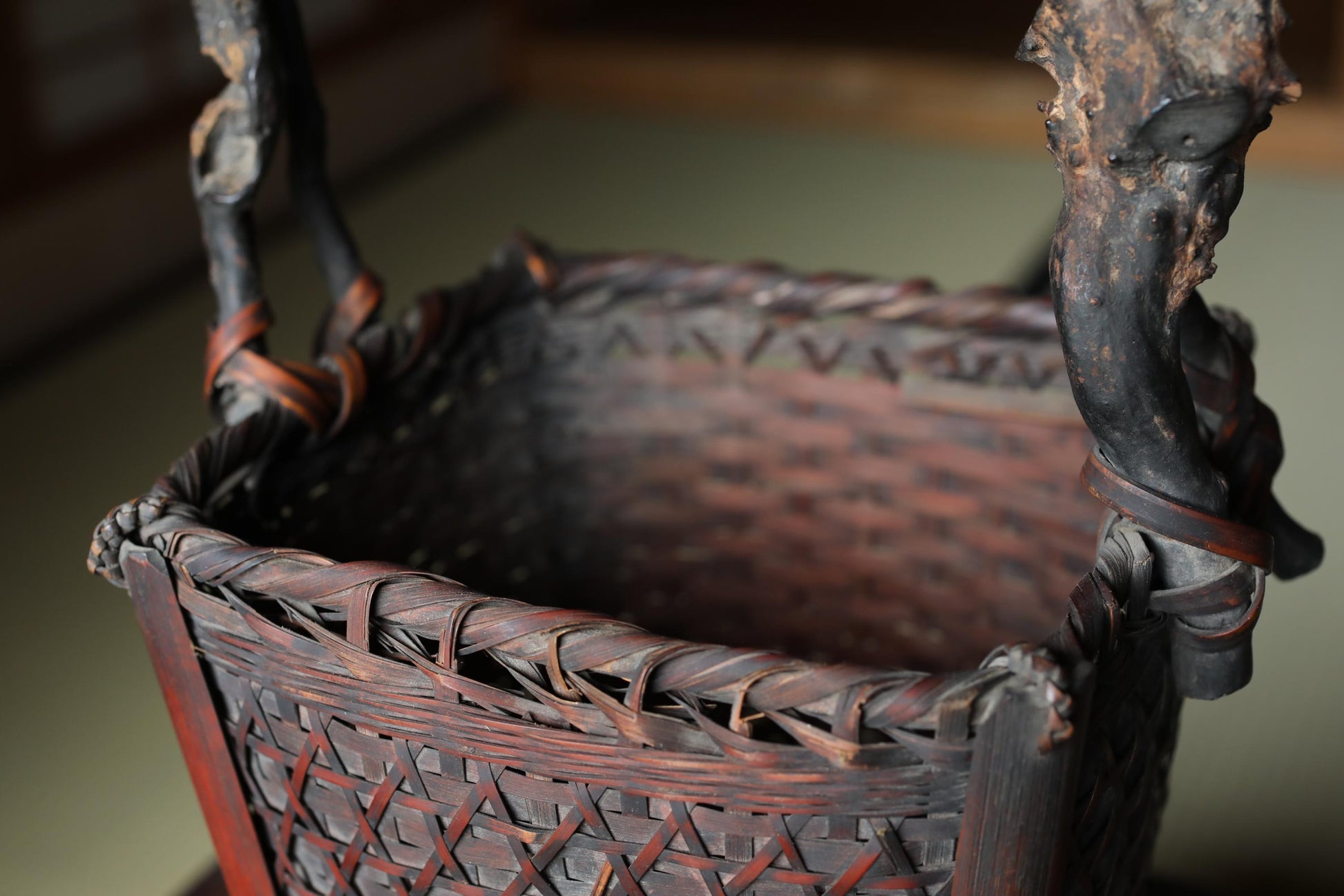 a close-up view of a woven basket with a dark brown color and intricate patterns.
