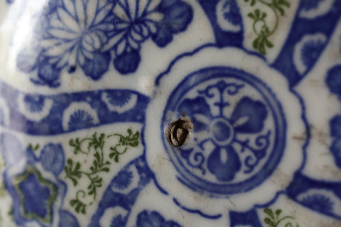 a close-up view of a blue and white ceramic plate with intricate floral designs.