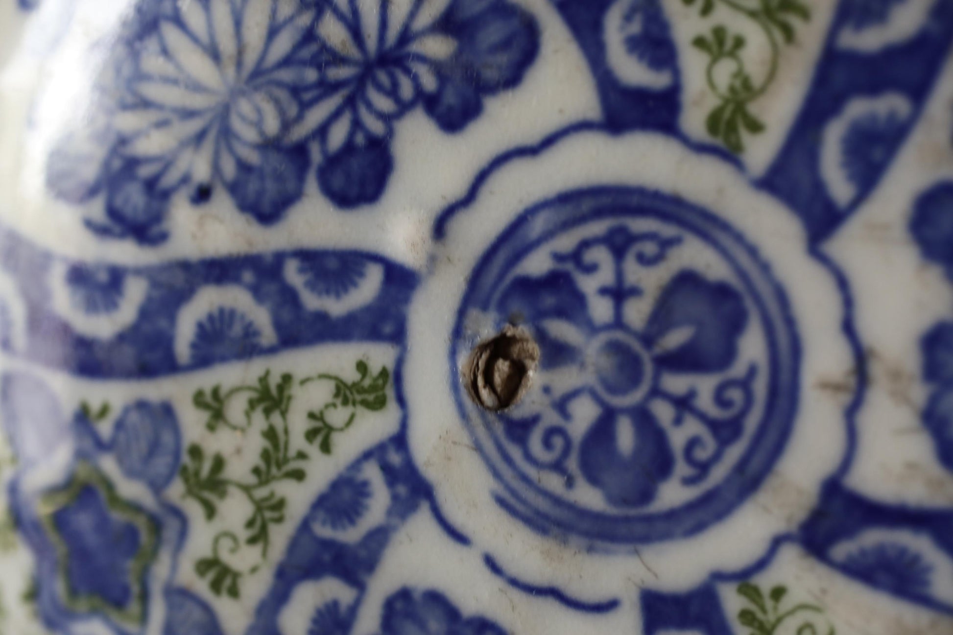 a close-up view of a blue and white ceramic plate with intricate floral designs.