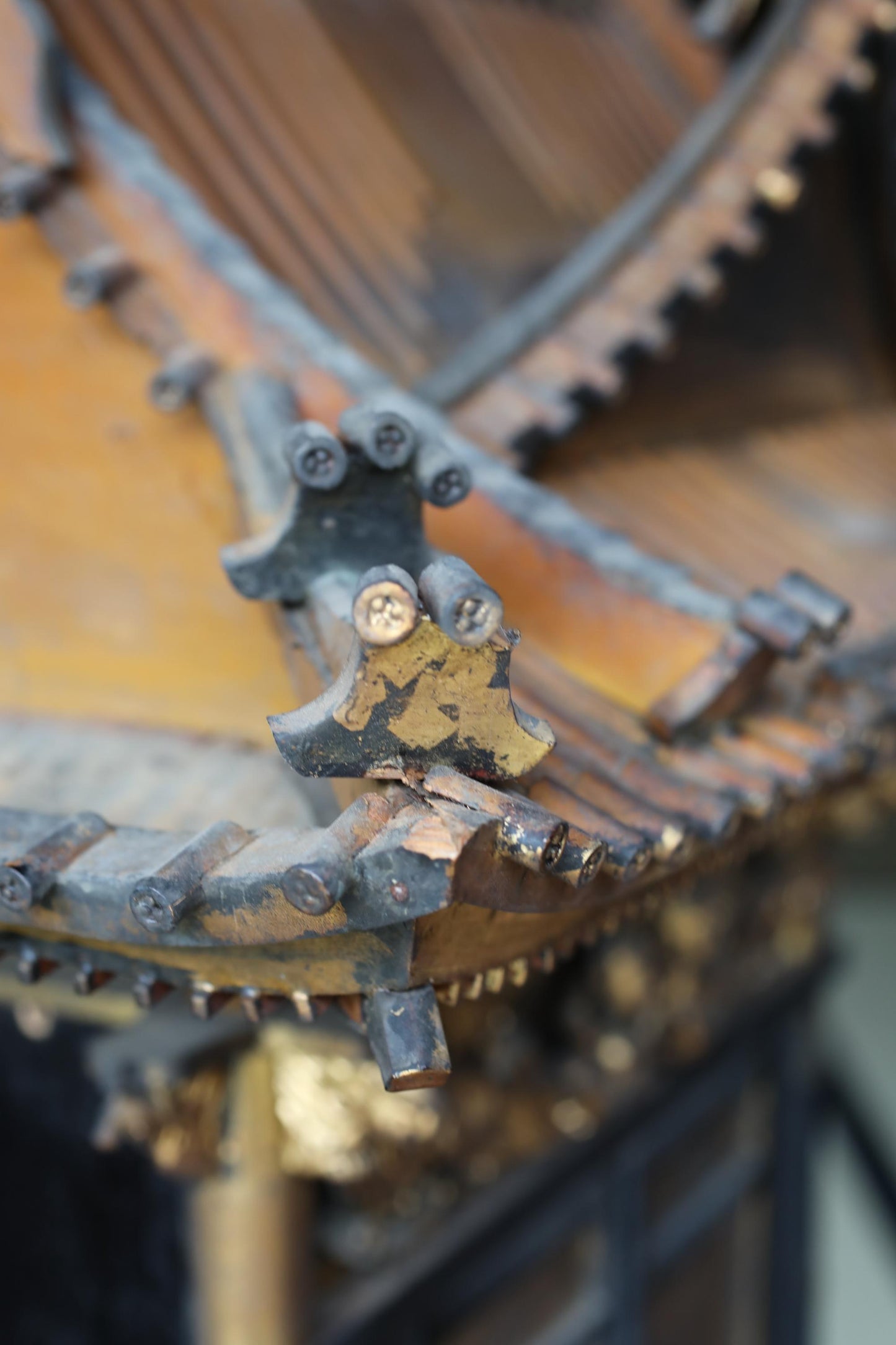 A close-up view of an ornate, wooden structure with intricate details and a weathered appearance.