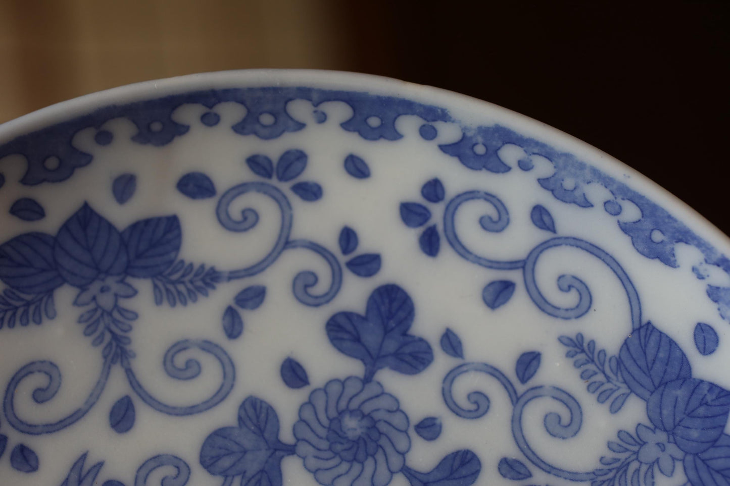 A close-up view of a decorative blue and white plate with intricate floral patterns.