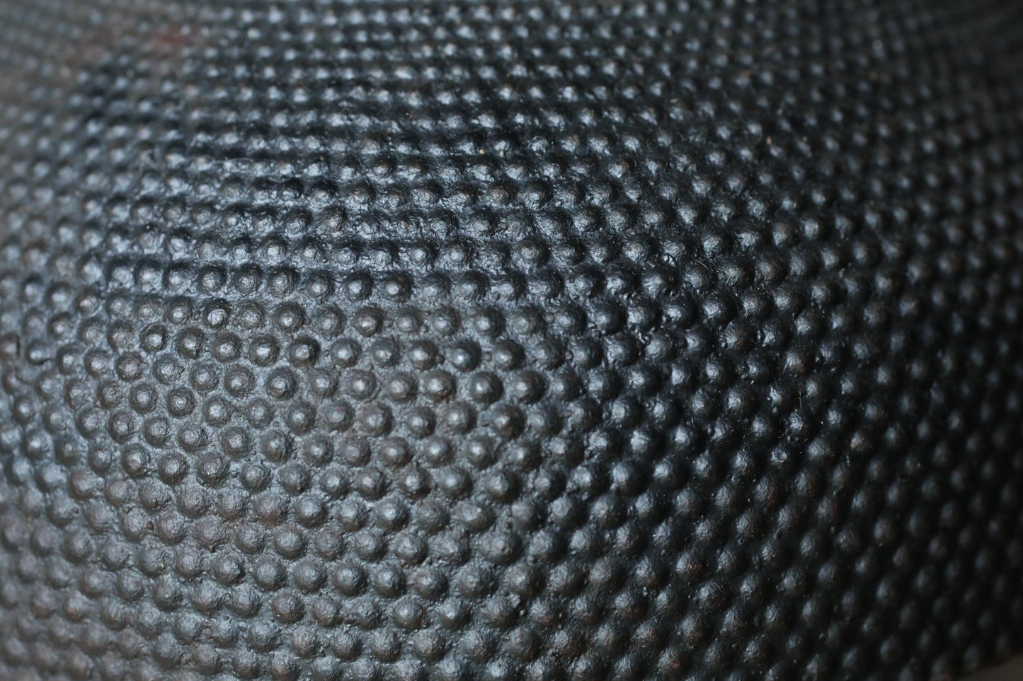 a close-up view of a textured surface with a repeating pattern of small circles or dots, creating a visually striking and intricate design.