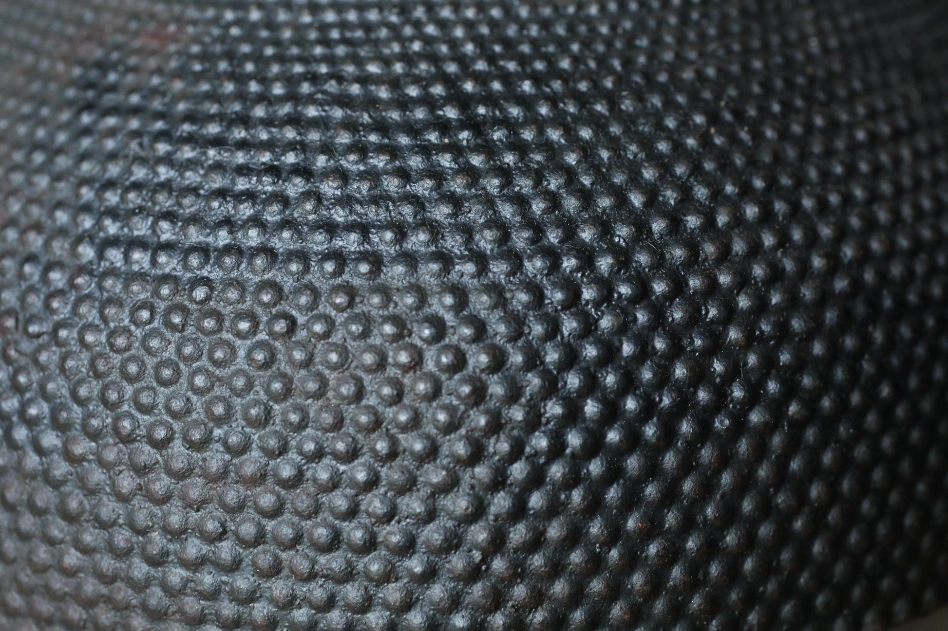 a close-up view of a textured surface with a repeating pattern of small circles or dots, creating a visually striking and intricate design.