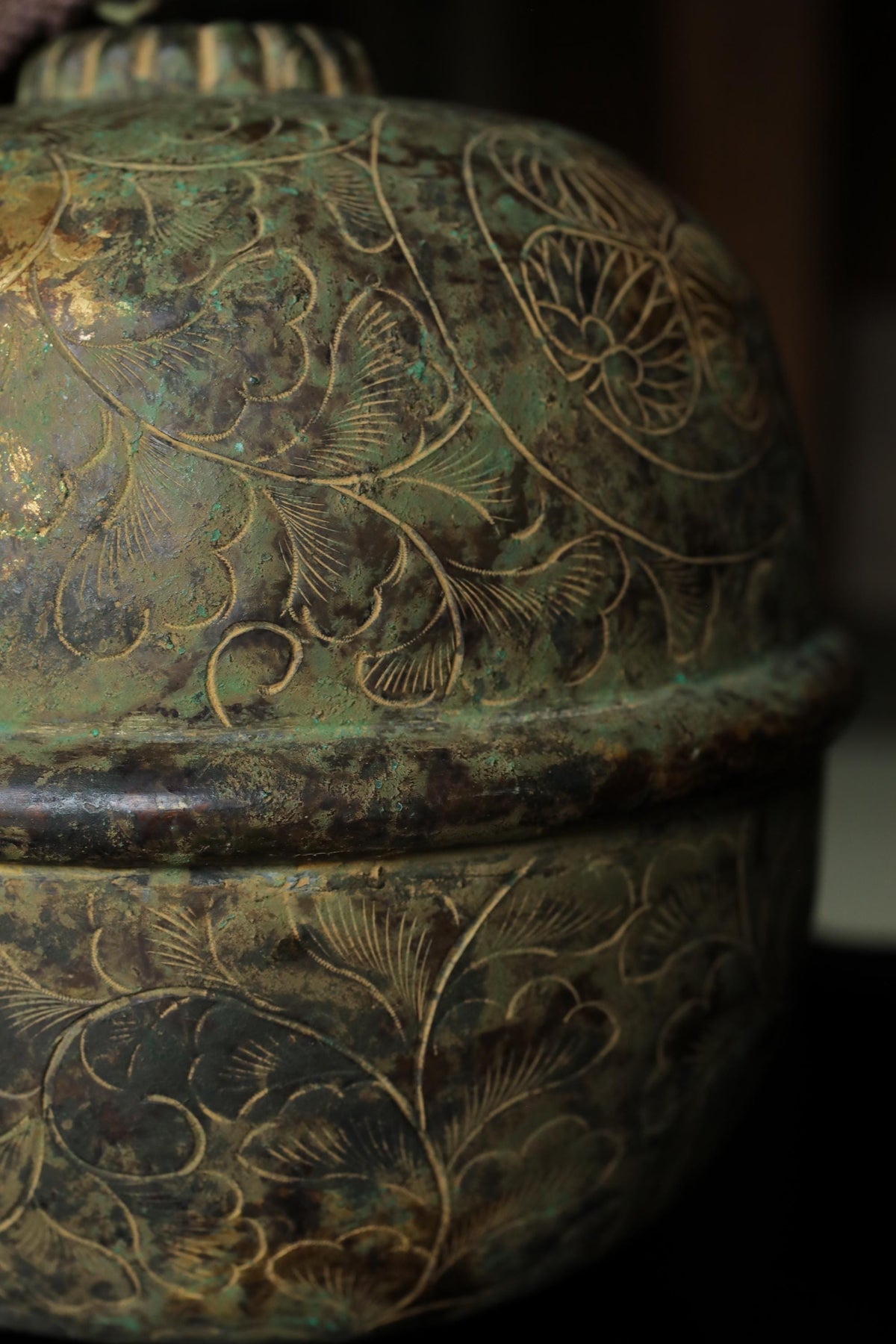 a close-up view of a decorative metal object with intricate floral patterns and designs.