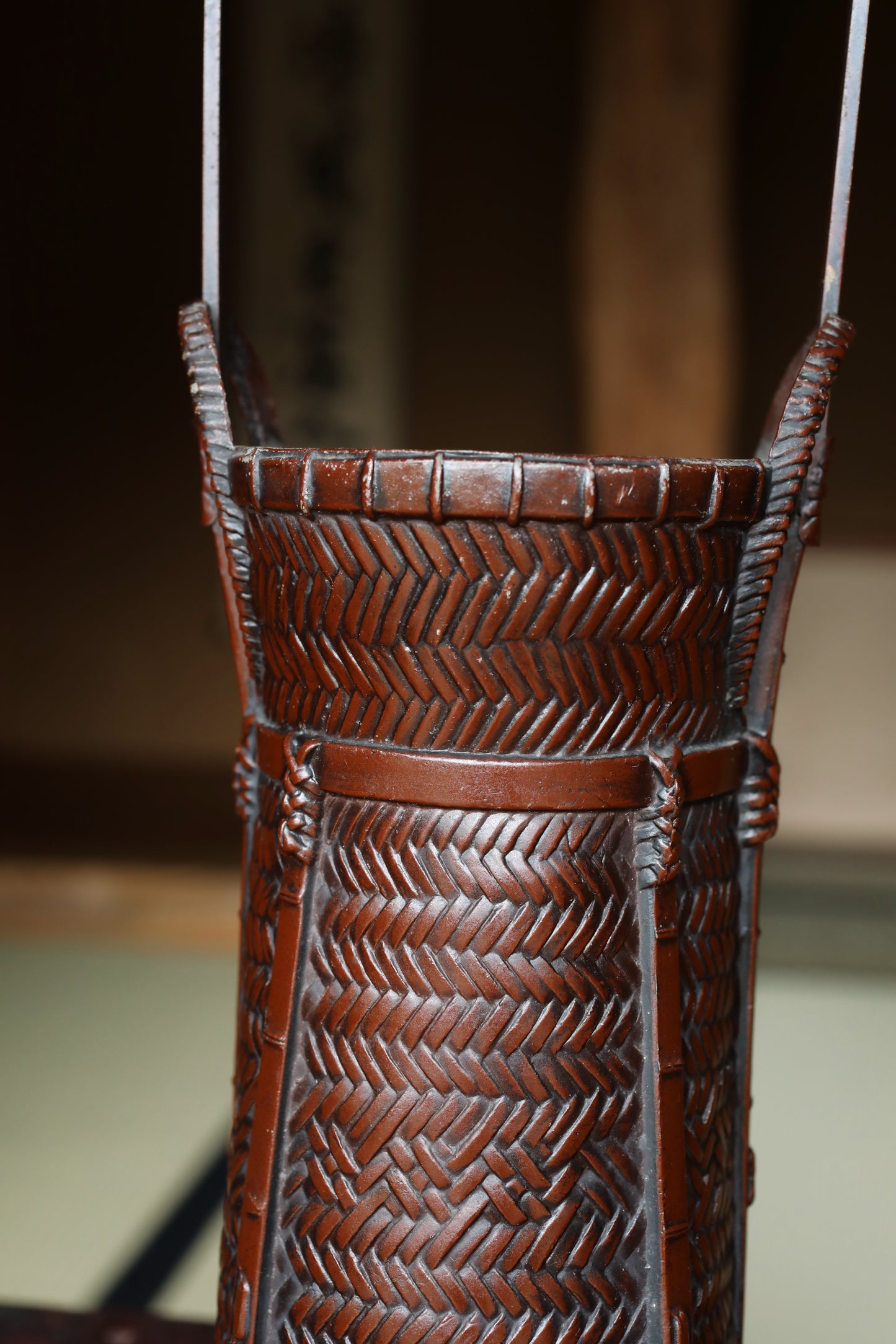 A close-up image of a brown woven basket with a textured pattern.
