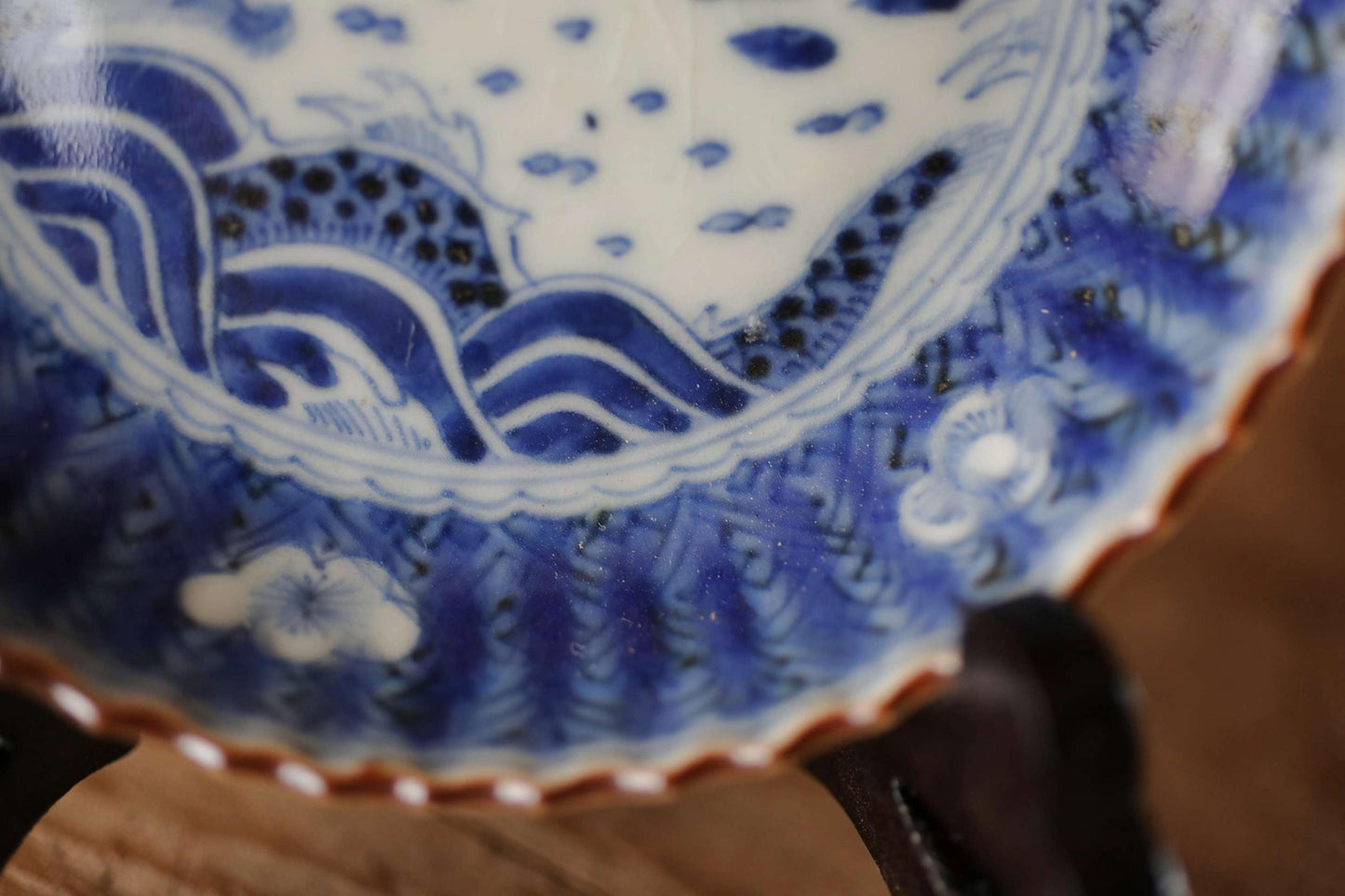 A close-up view of a decorative blue and white porcelain plate with intricate patterns and designs.
