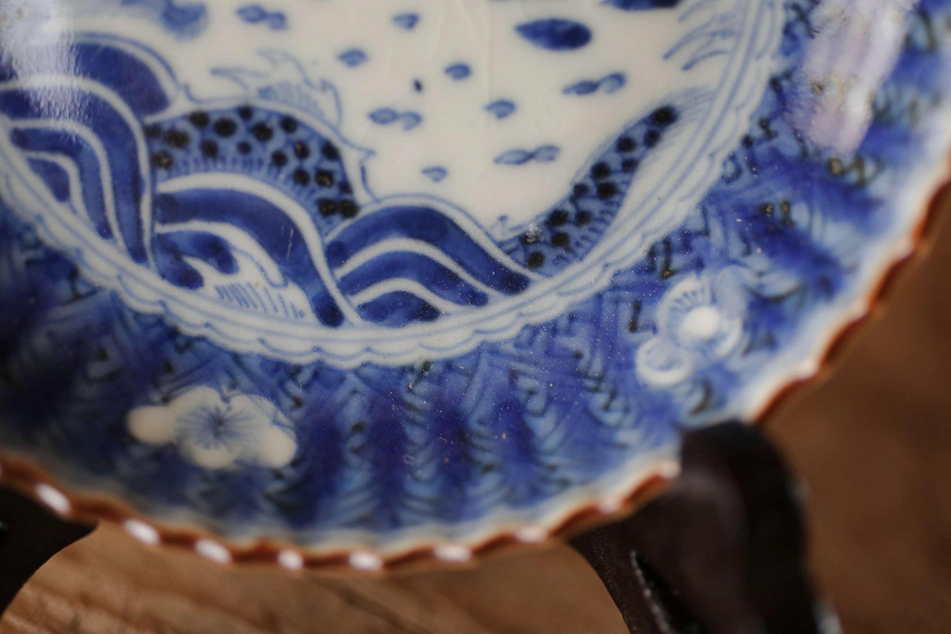 A close-up view of a decorative blue and white porcelain plate with intricate patterns and designs.