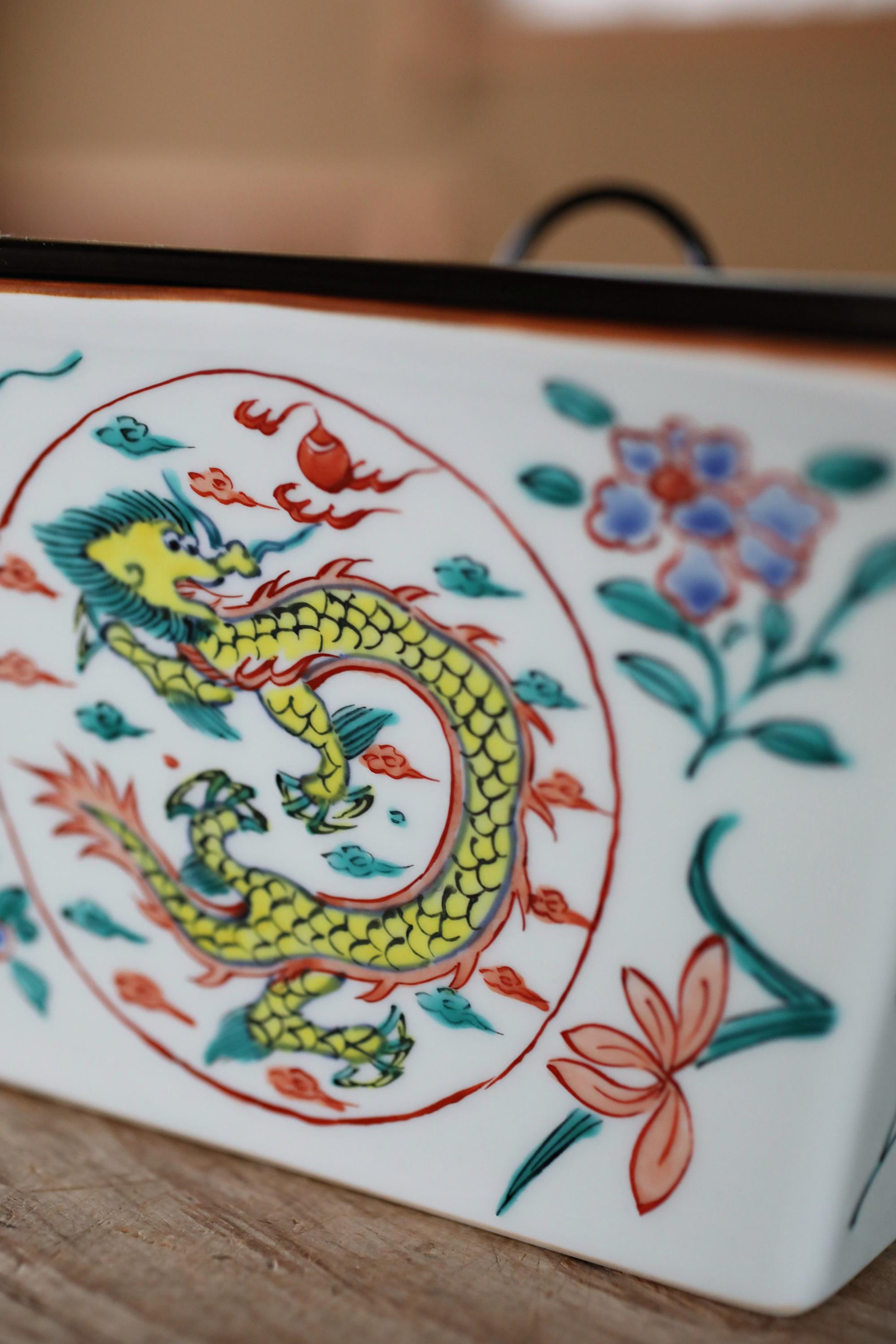 a decorative ceramic piece with a vibrant dragon design.