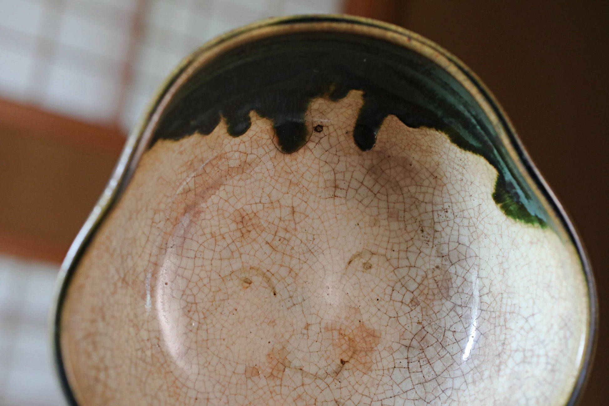 A close-up image of a ceramic bowl with a face-like design on its surface.
