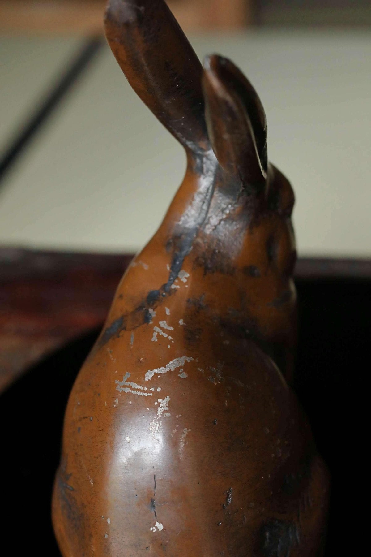 A close-up image of a brown, weathered metal rabbit figurine.