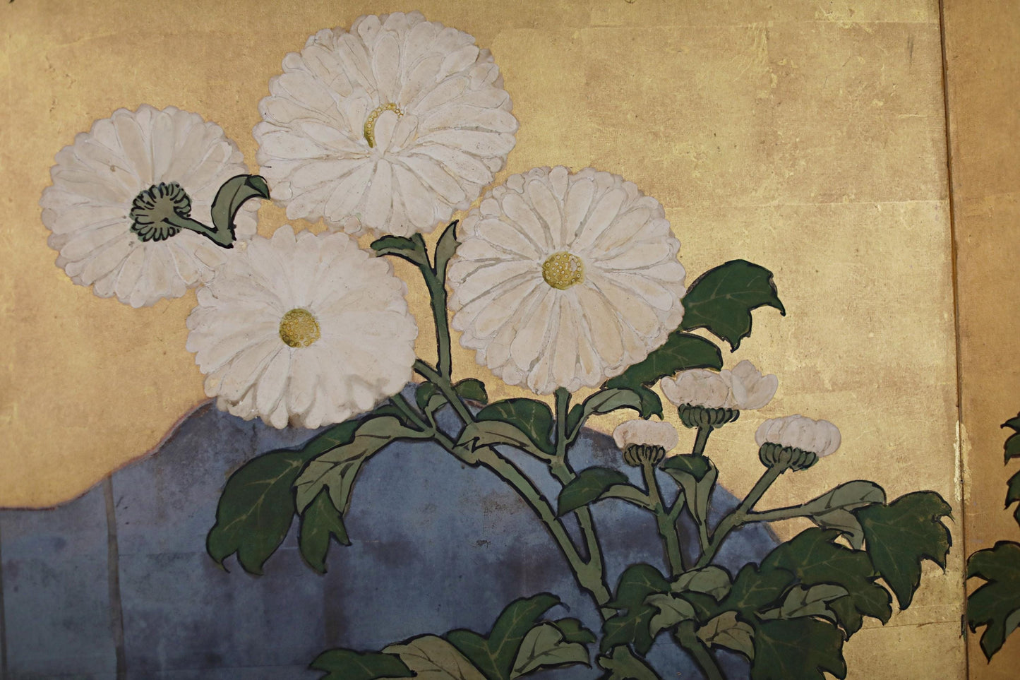 a close-up view of white flowers with green leaves, arranged in a stylized manner.