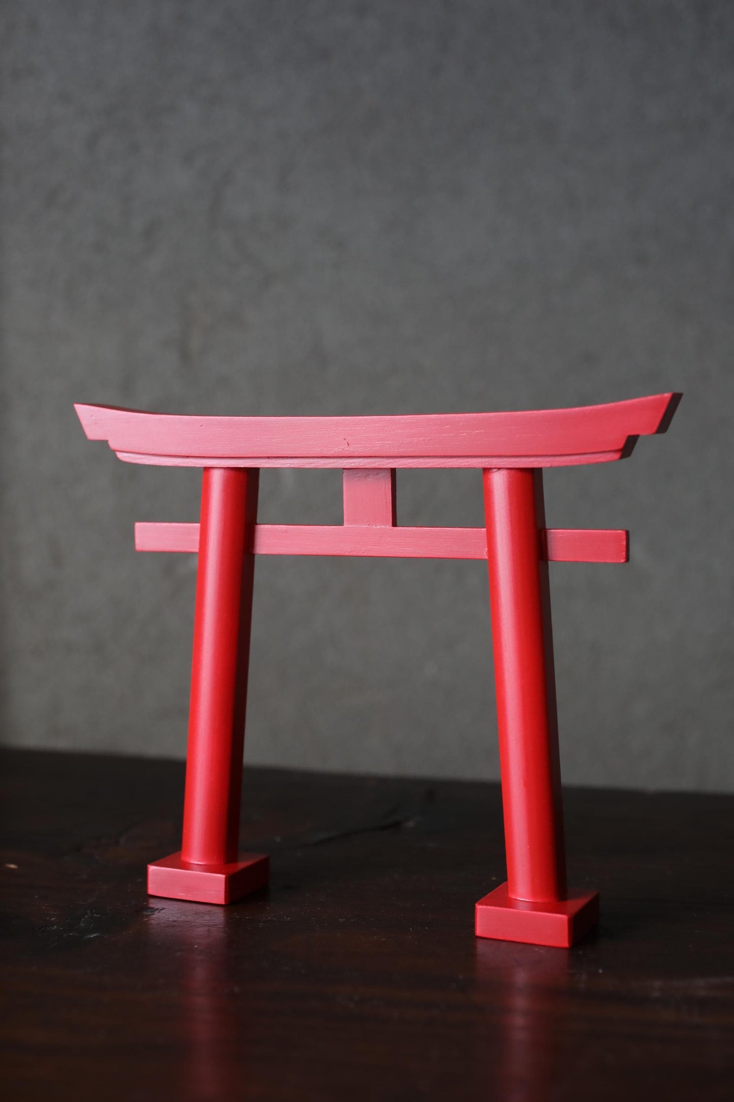 A red torii gate, a traditional Japanese Buddhist gate, is prominently featured in the image.