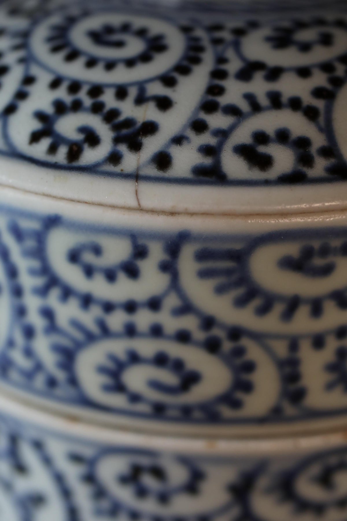 A close-up view of a decorative ceramic piece with a blue and white floral pattern.