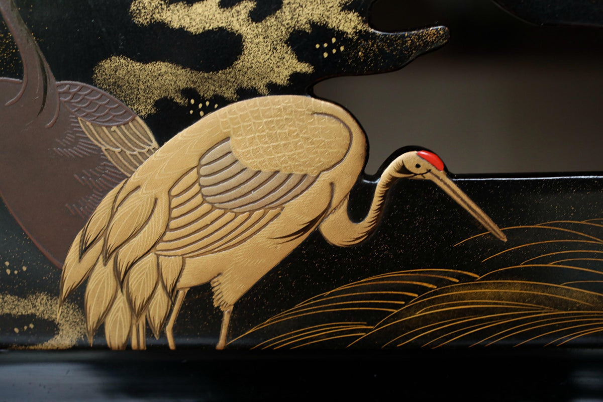 a close-up of a detailed, intricately designed bird, possibly a crane, with its long beak and distinctive features. The background is dark and features a pattern of waves and clouds, creating a serene and natural atmosphere. The bird appears to be the main focus of the image, with the background elements providing a contrasting backdrop.