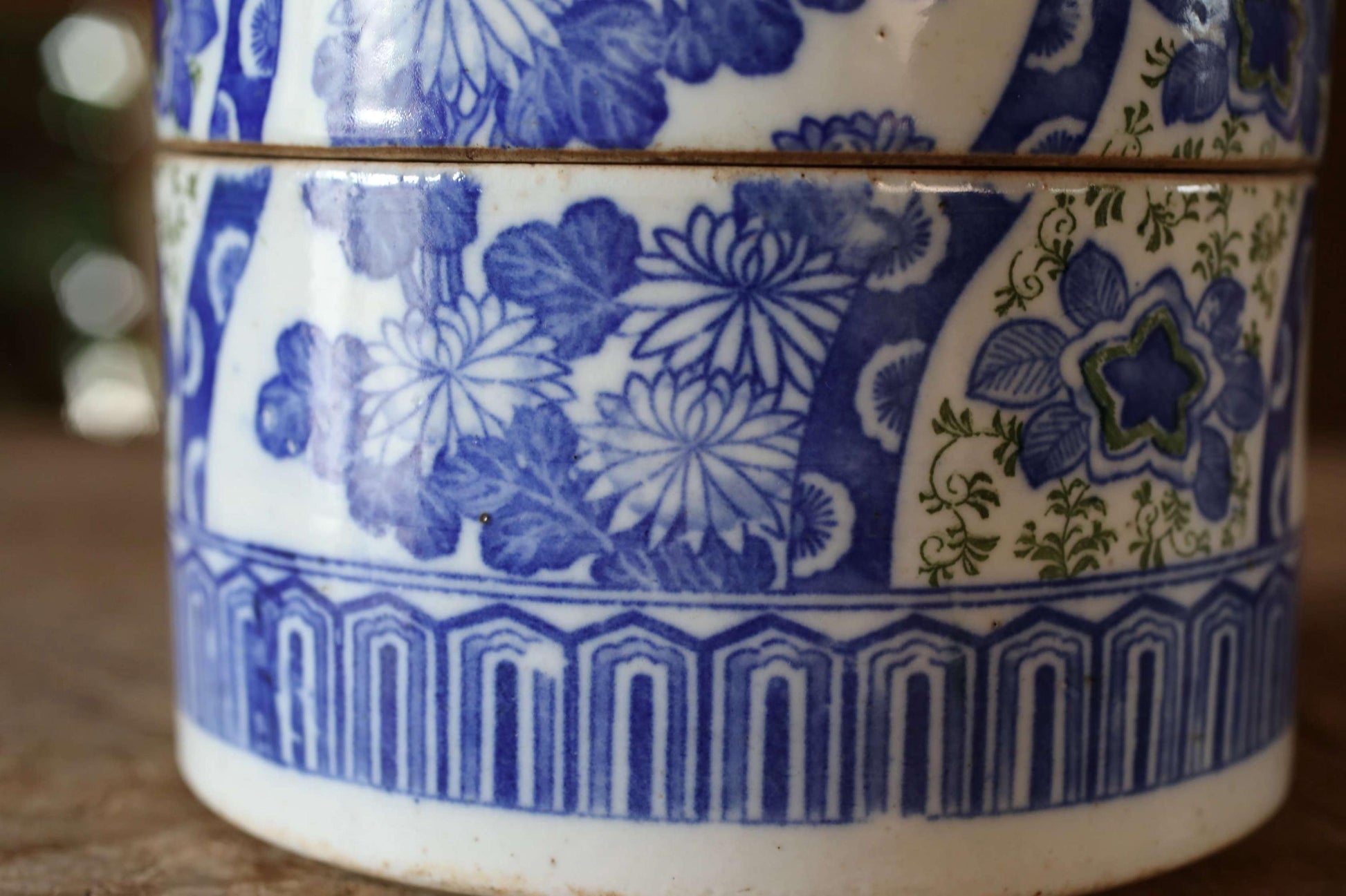 A close-up view of a decorative ceramic vase with a blue and white floral pattern.