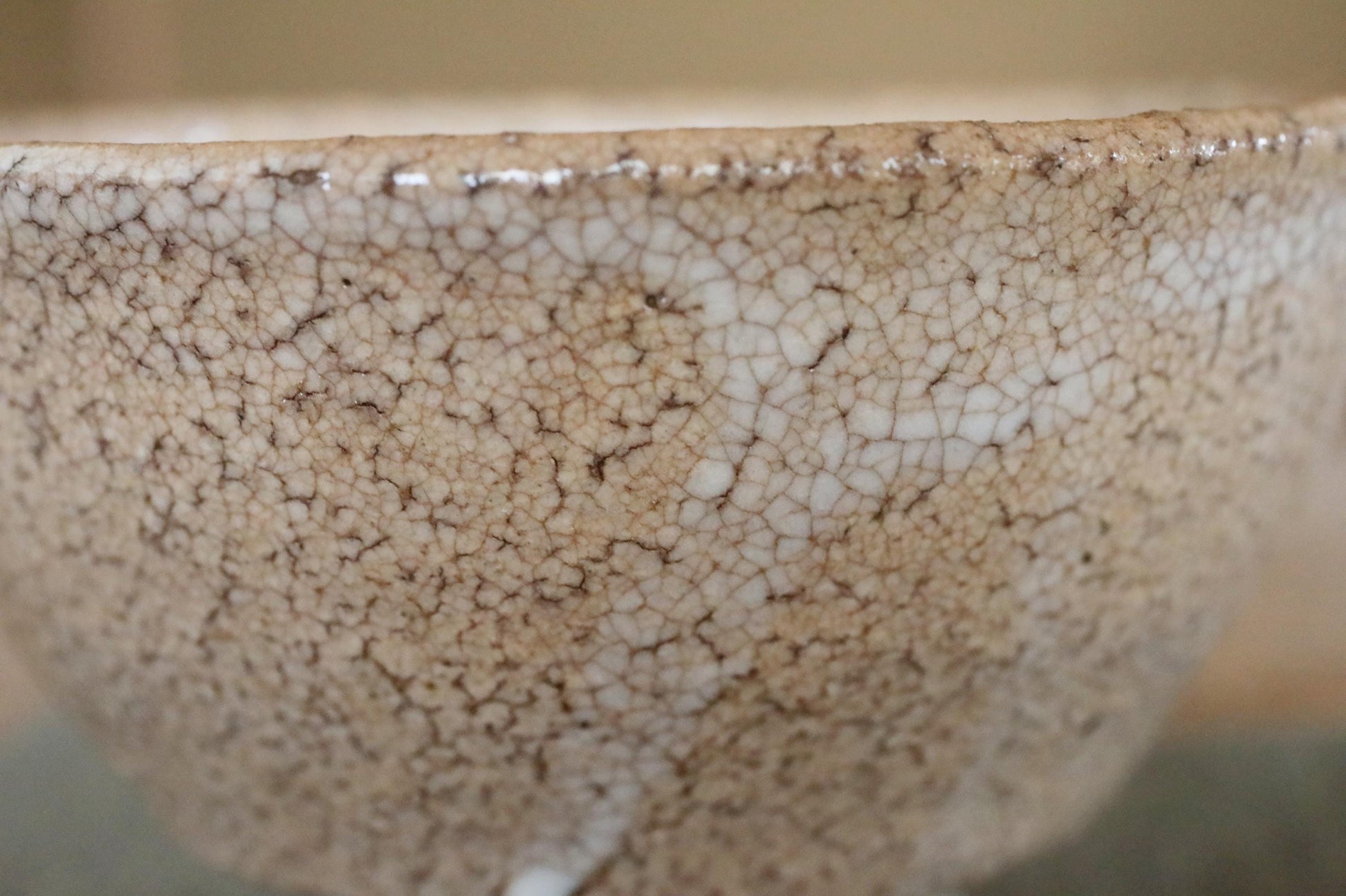 A close-up image of a ceramic bowl with a textured, speckled surface.