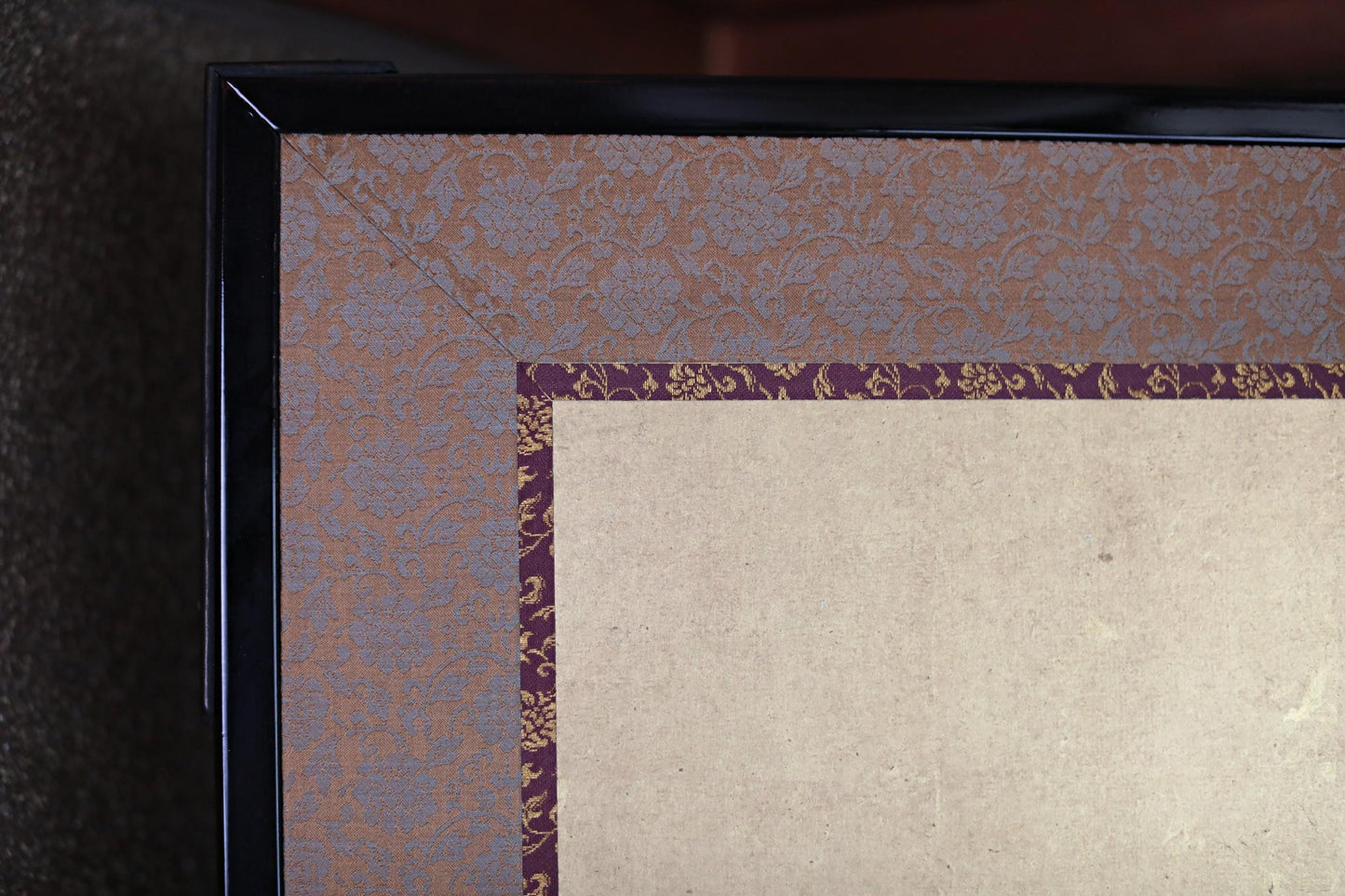 a close-up view of a decorative frame with a floral pattern on the border.