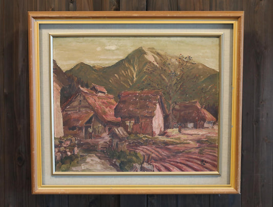 The image is a framed painting depicting a rural landscape with a village, mountains in the background, and a dirt road leading to the village.